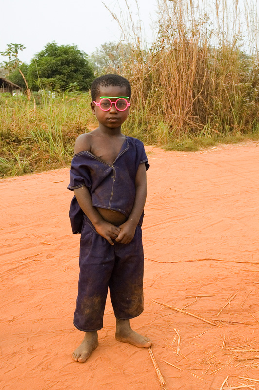  looking boy with his funny pink glasses in Baobeng-Fiema, Ghana.